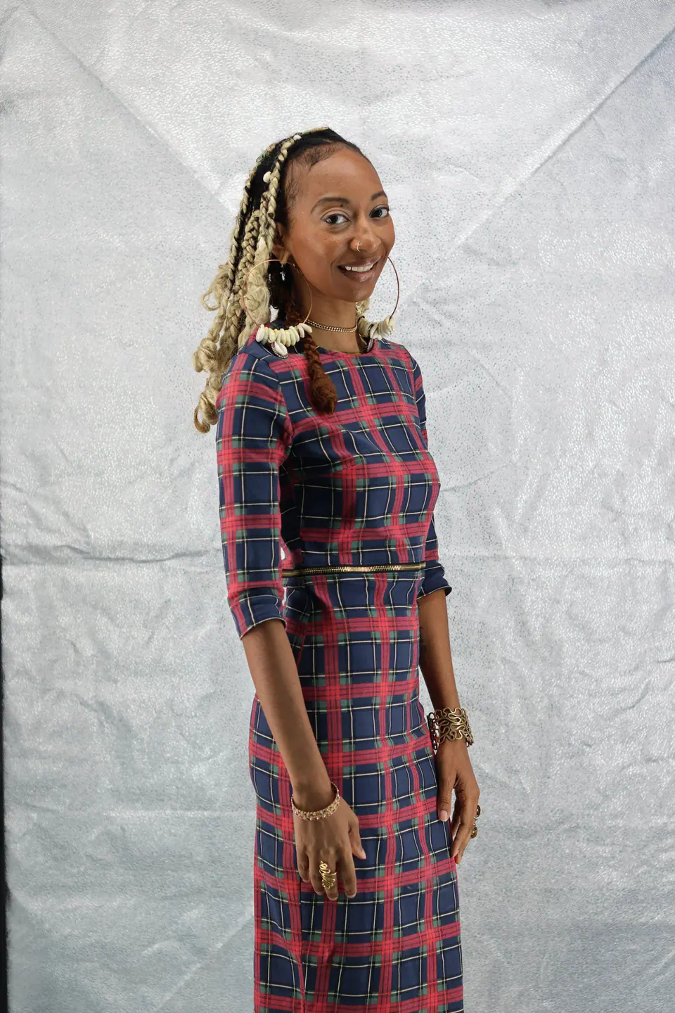 Donna Marie in a plaid dress, standing and smiling