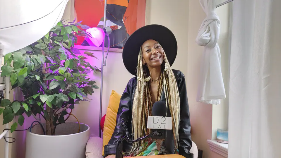 Donna Marie smiling on a podcast set with plants and purple light