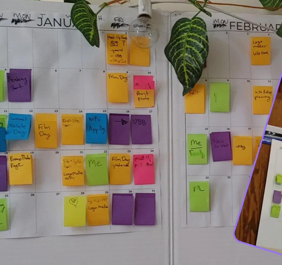 A wall calendar covered in colored sticky notes